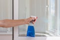 Houseworker clean plastic pvc windows with detergent. Royalty Free Stock Photo