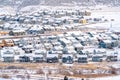 Housing area in the valley with homes amidst a landscape of snow in winter Royalty Free Stock Photo