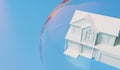 Housing bubble concept. White home in a transparent bubble. Property crisis. 3D Rendering Royalty Free Stock Photo