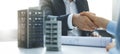 Housing development and investment business - businessmen handshake after agreement of apartment building construction. banner