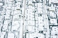 Housing estate in the suburbs covered with fresh snow. bird`s eyes view