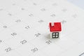 Housing, property or real estate or mortgage payment concept, miniature house with red roof on the end of month 31th date white