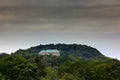 Houska castle in Czech Republic, Central Bohemia, Europe. State caste, hiden in green forest, dark grey clouds. Tower house in lan