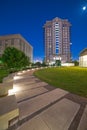 Houston municipal courts with Illuminated pathway concrete sidewalk at park square, downtown skyscrapers, office buildings during Royalty Free Stock Photo