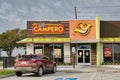 Pollo Campero restaurant storefront exterior and parking lot in Houston, TX.