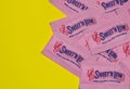 Sweet `N Low packets scattered loosely on a yellow background.