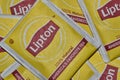 Unopened Lipton tea bag square packets scattered loosely.