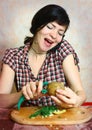 Houswife peeling potato speakin cell phone Royalty Free Stock Photo