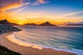 Hout bay harbour has a golden sunset over the ocean.