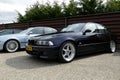 HOUTEN, THE NETHERLANDS - APRIL 19, 2014: Dark BMW M5 E39 on display during Cars show. Royalty Free Stock Photo