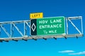 HOV lane entrance road sign. Blue sky