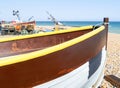 Traditional colourful fishing boats of South England pulled up on beach