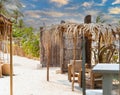 Hovels and chairs made of wood and reeds for the rest of tourists on the beach