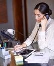 How can we help you today. a beautiful young woman working at her desk. Royalty Free Stock Photo