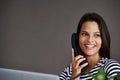 How can I help you, today. an attractive young woman talking on the phone. Royalty Free Stock Photo