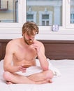 How coffee affects your body from first sip. Man handsome macho with muscular torso relaxing on bed with cup of coffee Royalty Free Stock Photo