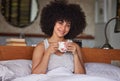 How could he know he had found treasure. Portrait of a beautiful young woman having a cup of coffee in bed at home. Royalty Free Stock Photo