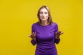 How could you? Portrait of disappointed unhappy woman asking what do you want. indoor studio shot isolated on yellow background