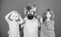 How crazy is your father. Man bearded father and kids girls wear colorful wig violet background. Friendly family wear
