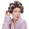 How curly will it be. Studio shot of a young woman in hair rollers and a robe. Royalty Free Stock Photo