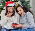 How did you know I needed this. two young women opening up gifts during Christmas time at home. Royalty Free Stock Photo