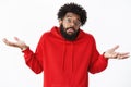 How do I know. Portrait of clueless and unaware unbothered african-american male coworker with beard in glasses and red Royalty Free Stock Photo