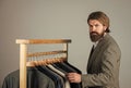 How do you like this. Man clothing in boutique. Man with suit. tailor in his workshop. Handsome bearded fashion man in Royalty Free Stock Photo