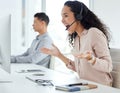 How does she do it. a young call centre agent cheering while working on a computer in an office with her colleague in