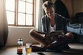 This is how I spend my mornings every weekend. a young man reading a book while sitting on the floor at home. Royalty Free Stock Photo