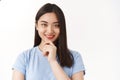 How interesting. Cute creative asian female freelancer ponder ideas choices smiling delighted touch chin thinking making