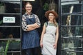 How may we help you. Cropped portrait of two young business owners standing at the entrance of their floristry together. Royalty Free Stock Photo