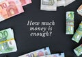 HOW MUCH MONEY IS ENOUGH Quote Euro bills are creative layout. Business concept, development perspective. Flat lay. Top Royalty Free Stock Photo