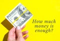 HOW MUCH MONEY IS ENOUGH Quote Female hand holding dollars close up. Money currency. Online shopping. Giving money Royalty Free Stock Photo