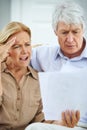 How is this possible. an elderly couple looking frustrated while going over their paperwork together. Royalty Free Stock Photo