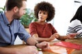 How should we go about this. two design professionals having a discussion while seated at a table.