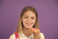 How tame childs sweet tooth. Kid rewarded for good behavior with sugary treats. Girl cute smiling face holds sweet donut