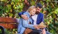 How to find girlfriend with common interest. Meeting people with similar interests. Man and woman sit bench park. Read Royalty Free Stock Photo