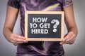 How To Get Hired. Woman holding a chalk board Royalty Free Stock Photo