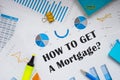 HOW TO GET A Mortgage? inscription on the piece of paper Royalty Free Stock Photo