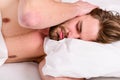 How to get up in morning feeling fresh. Late morning overslept. Man handsome guy lay in bed in morning. Tips on how to Royalty Free Stock Photo