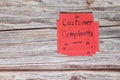 How to handle customer complaint concept. Hand holding red note with written word complaints