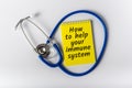 How to help your immune system - message on notepad near Stethoscope. Boost immune system as medical concept.