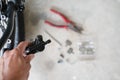 How to maintenance a mtb hydraulic disc brake caliper : Repairman holding a Hydraulic rear disc brake caliper on a mountain bike. Royalty Free Stock Photo