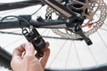 How to maintenance a mtb hydraulic disc brake caliper : Repairman holding a Hydraulic rear disc brake caliper on a mountain bike.