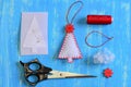 How to make a felt Christmas tree set. Felt Christmas tree crafts, paper template, thread, needle, scissors on a wooden table Royalty Free Stock Photo