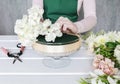 How to make floral decorations on summer party table. Centerpiece with rose, dahlia and hortensia flowers Royalty Free Stock Photo