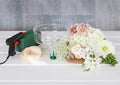 How to make floral decorations on summer party table. Centerpiece with rose, dahlia and hortensia flowers Royalty Free Stock Photo