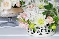 How to make floral decorations on summer party table. Centerpiece with rose, dahlia and hortensia flowers Royalty Free Stock Photo