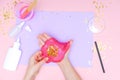 How to make slime at home. Children art project. DIY concept. Kids hands making slime toy on pink. Step by step photo