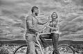 How to meet girls while riding bike. Man with beard and shy blonde lady on first date. Couple just meet to become Royalty Free Stock Photo